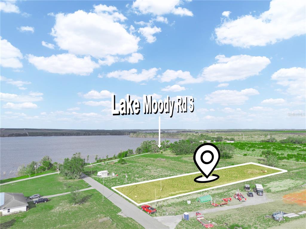 An aerial view shows a rectangular plot of land near a lake — 151 EDDIE FLOOD ROAD, FROSTPROOF, FL