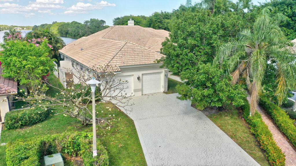 An aerial view of a house with a tiled roof, two-car garage, and paved driveway — 1823 SW 17th Street, Boca Raton FL 33486, BOCA RATON, FL
