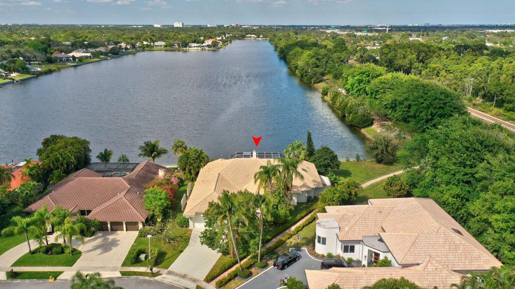 An aerial view of a waterfront house with a pool cage and a tile roof — 1823 SW 17th Street, Boca Raton FL 33486, BOCA RATON, FL