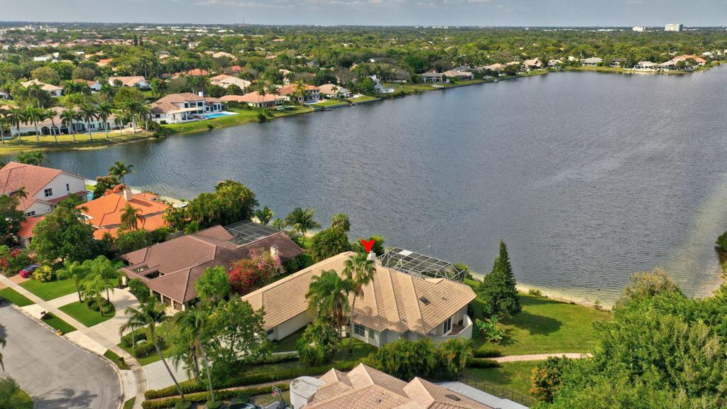 An aerial view of a waterfront house with a tiled roof and a screened pool — 1823 SW 17th Street, Boca Raton FL 33486, BOCA RATON, FL