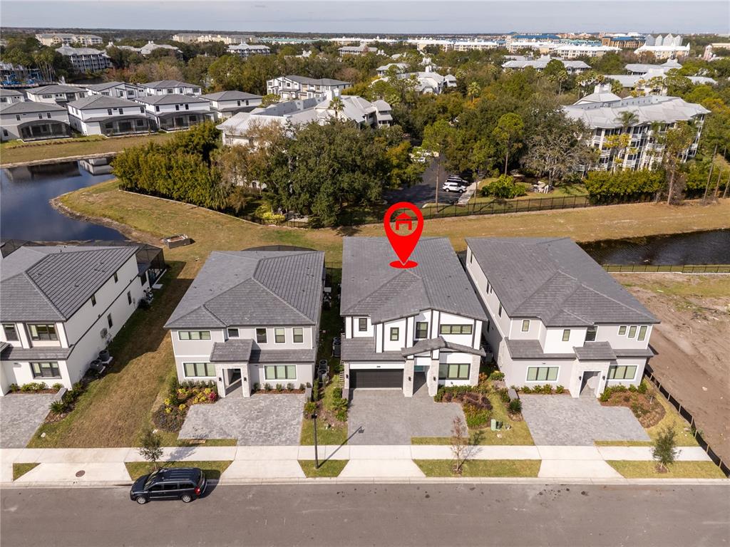 An aerial view shows a two-story house with a red location pin on its roof — 5674 HIGH SEAS DRIVE, ORLANDO, FL