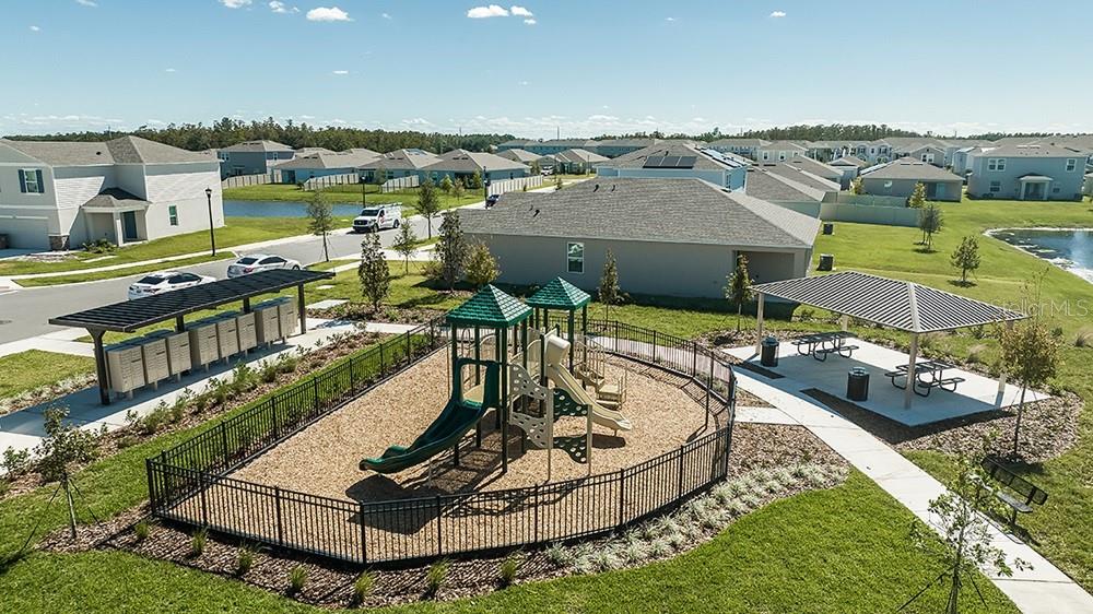 An outdoor playground with a slide and a covered picnic area in a residential neighborhood — 5485 ISLA SAONA DRIVE, KISSIMMEE, FL