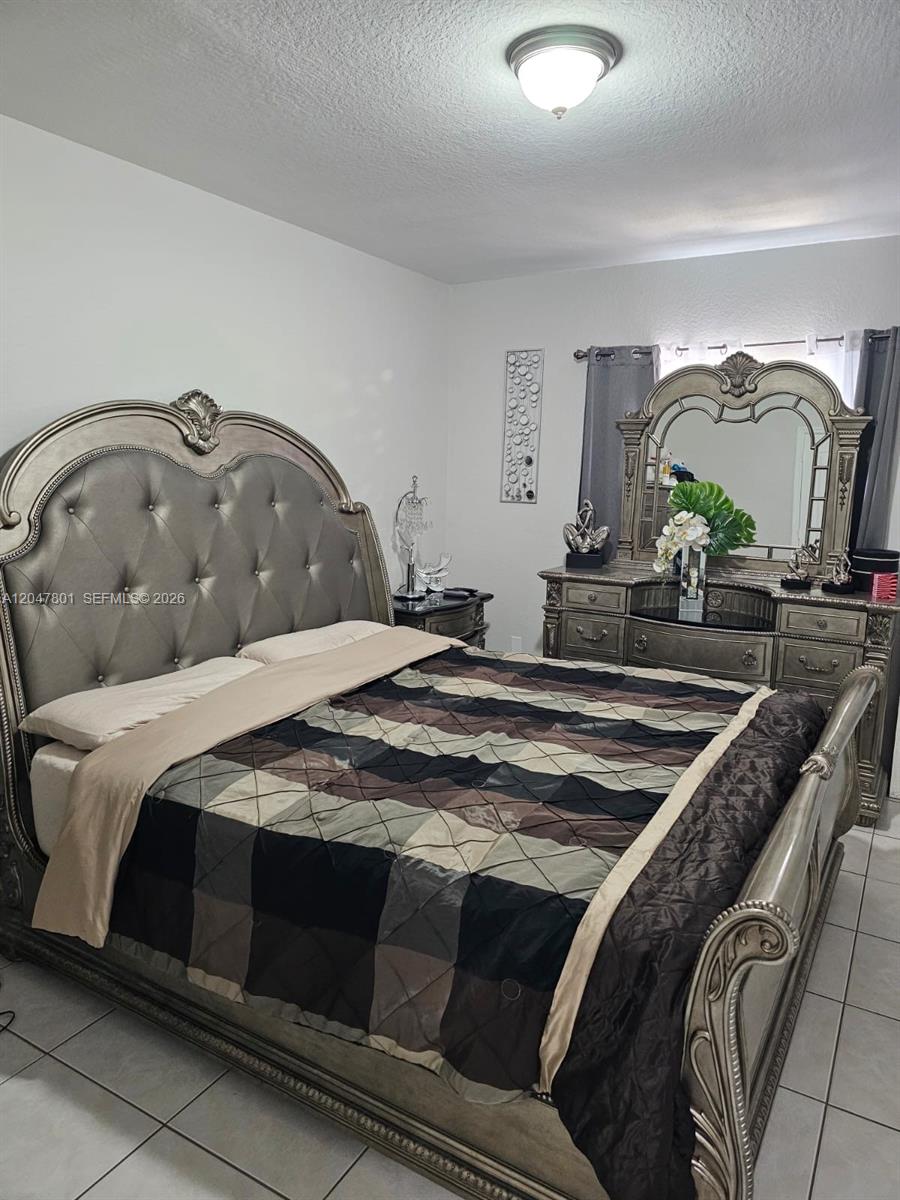 A bedroom features a large, ornate silver bed frame and a matching dresser with mirror — 7565 N Augusta Dr # 7567, Hialeah FL 33015, HIALEAH, FL