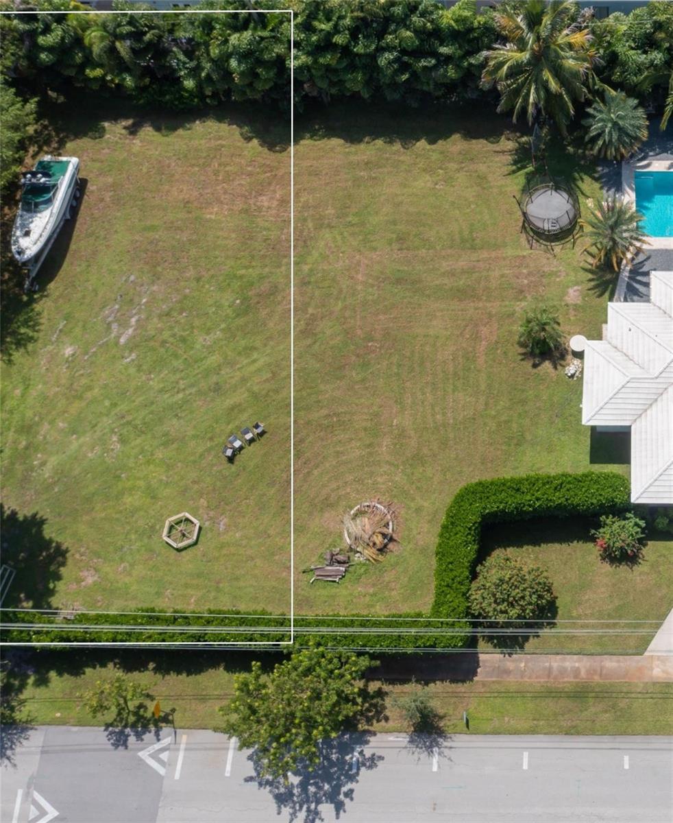 An aerial view shows two adjacent grassy residential lots with a boat and a pool — 0 NE 2nd Street, Pompano Beach FL 33060, POMPANO BEACH, FL