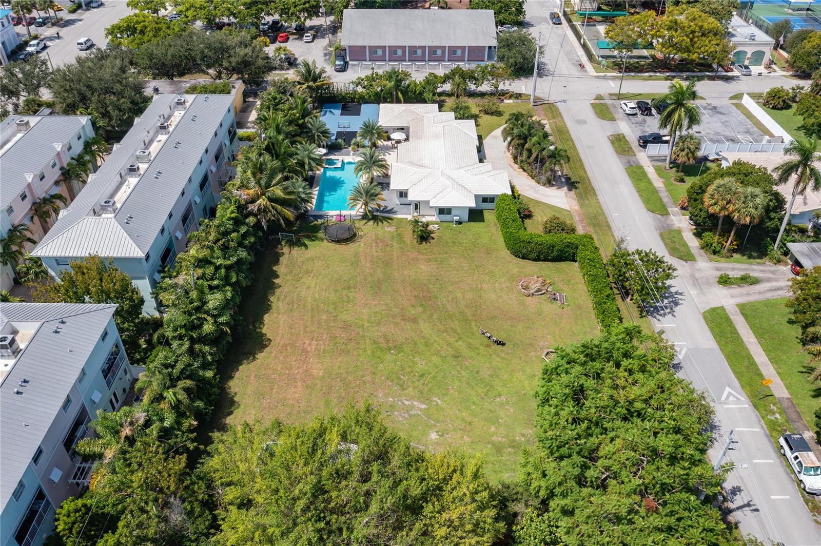 An aerial view shows a house with a pool and a large, grassy backyard — 0 NE 2nd Street, Pompano Beach FL 33060, POMPANO BEACH, FL