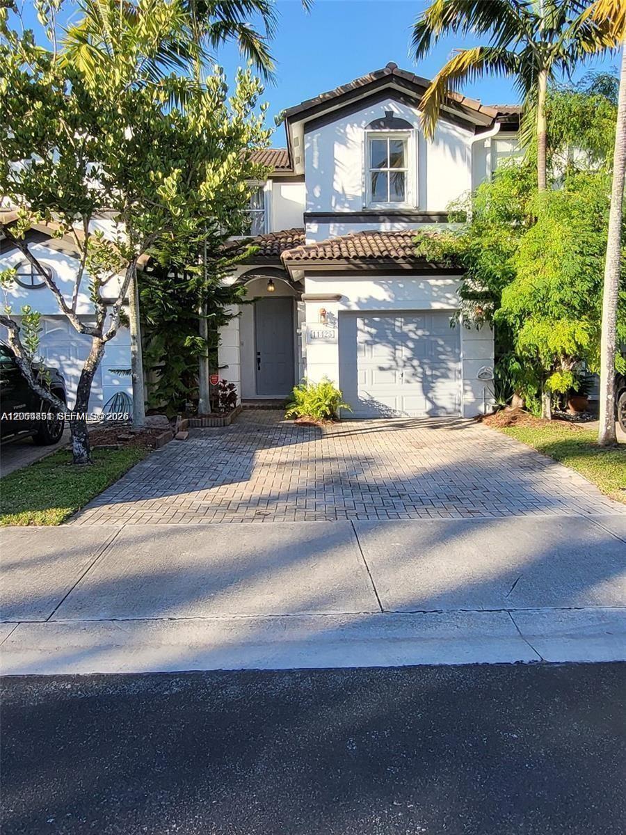 A two-story house with a paved driveway, a garage, and a front entrance — 11425 NW 76th Ter, Doral FL 33178, DORAL, FL