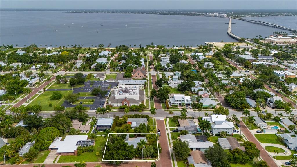 An aerial view shows a residential property highlighted in a neighborhood near the water — 311 GILL STREET, PUNTA GORDA, FL