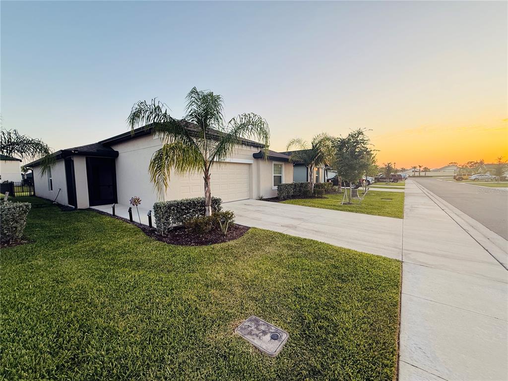 A single-story house with a beige exterior, a two-car garage, and a palm tree — 4034 SAN CLEMENTE COURT, NORTH FORT MYERS, FL