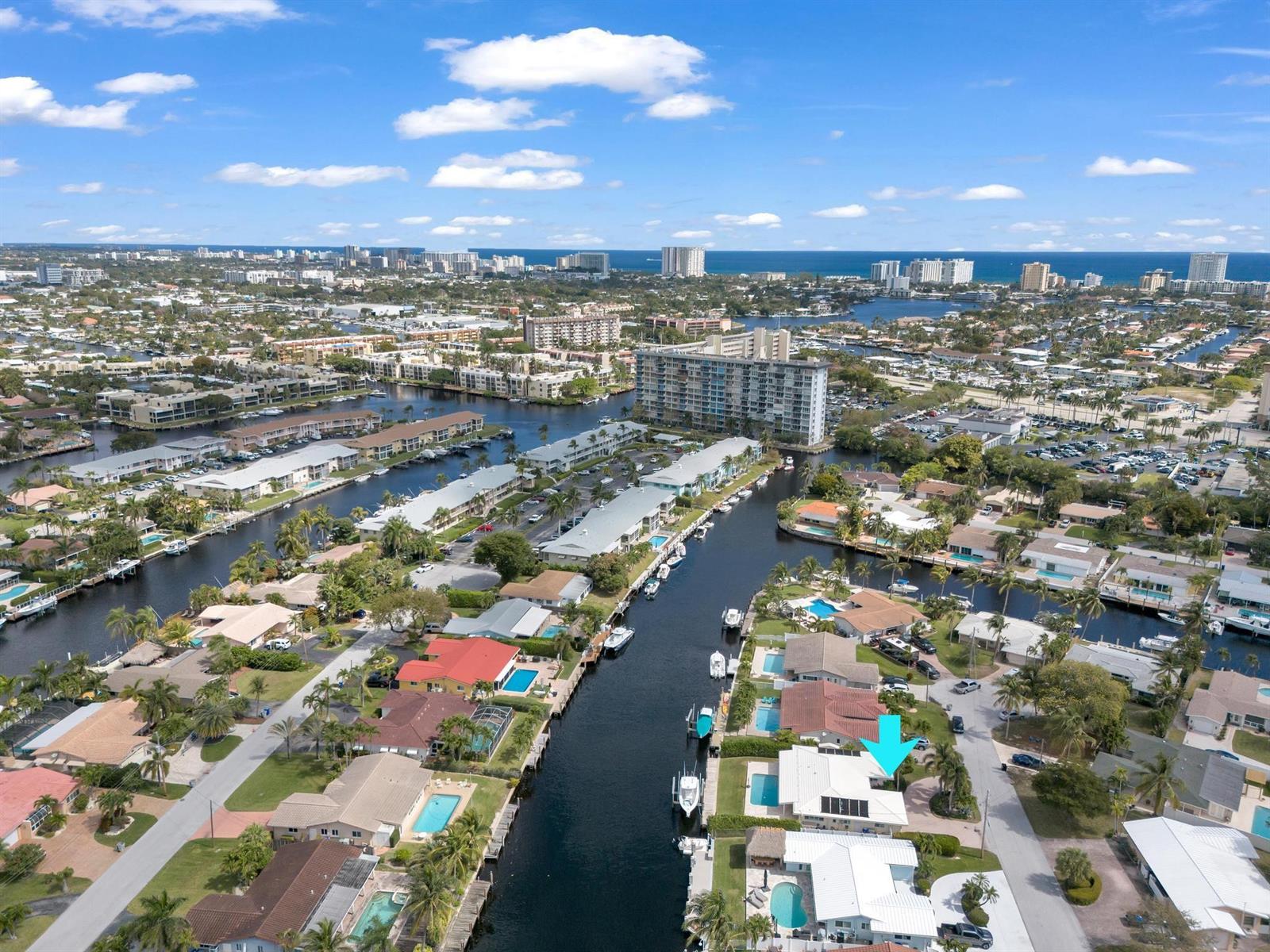 An aerial view shows a waterfront residential neighborhood with canals, swimming pools, and docked boats — 925 SE 10th Street, Pompano Beach FL 33060, POMPANO BEACH, FL