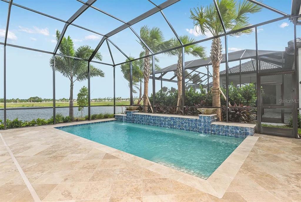 A screened-in patio features a rectangular swimming pool with a tiled water feature and pavers — 504 BOCELLI DRIVE, NORTH VENICE, FL