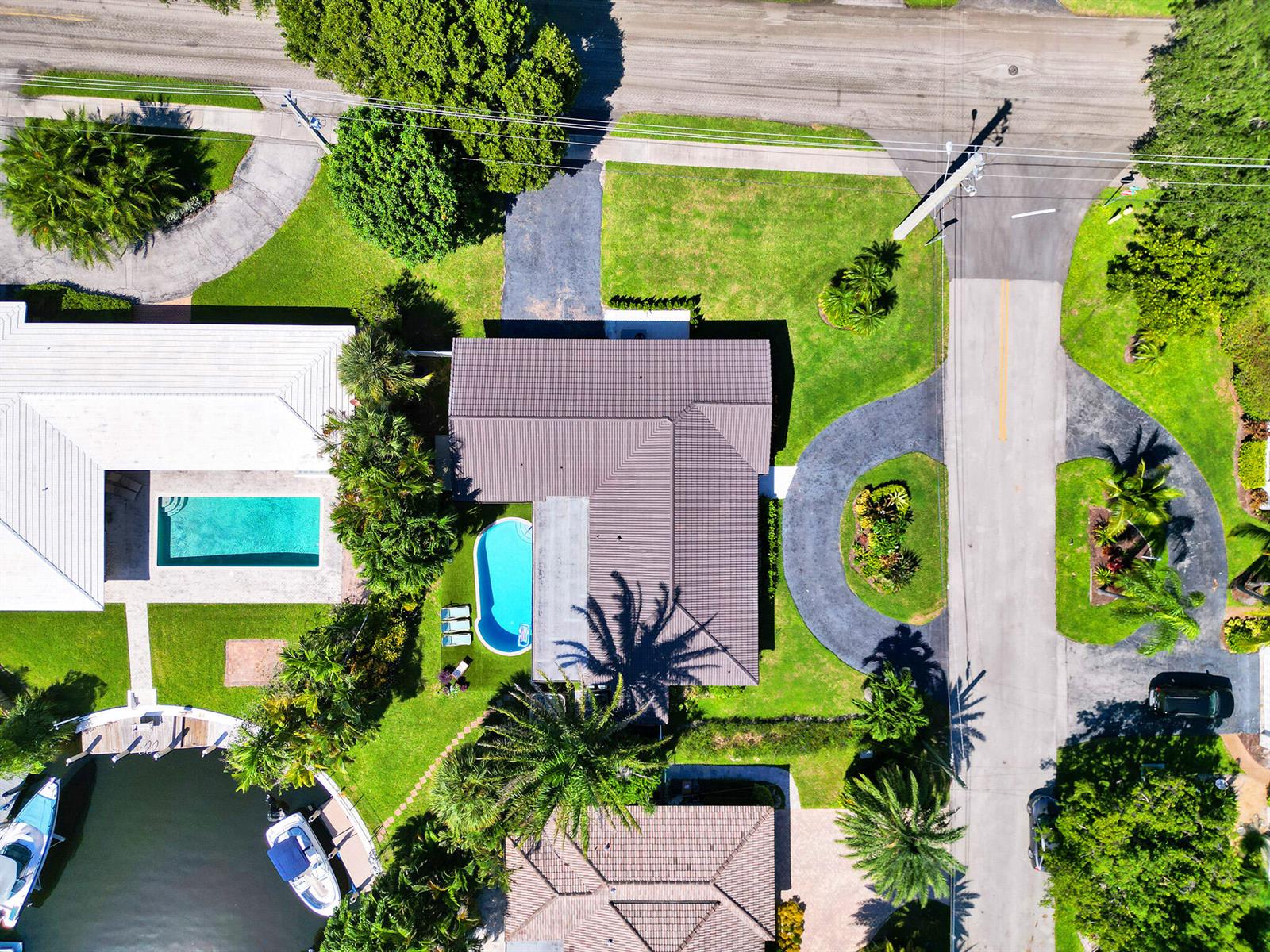 An aerial view shows a house with a pool, a boat dock, and surrounding landscaping — 3821 NE 29th Avenue, Lighthouse Point FL 33064, LIGHTHOUSE POINT, FL