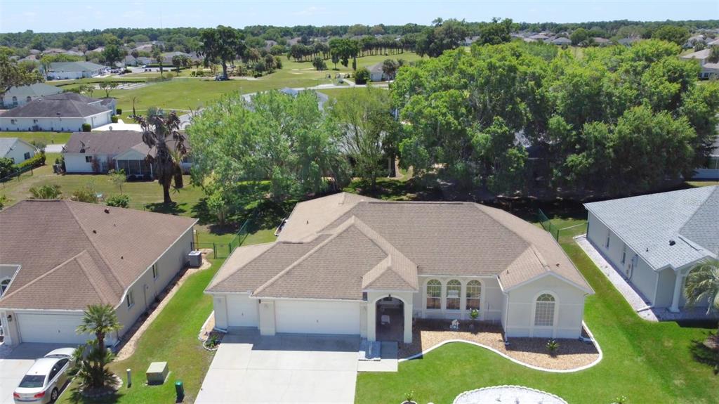 An aerial view of a suburban house with a tan roof and a concrete driveway — 5340 NW 26TH LANE, OCALA, FL