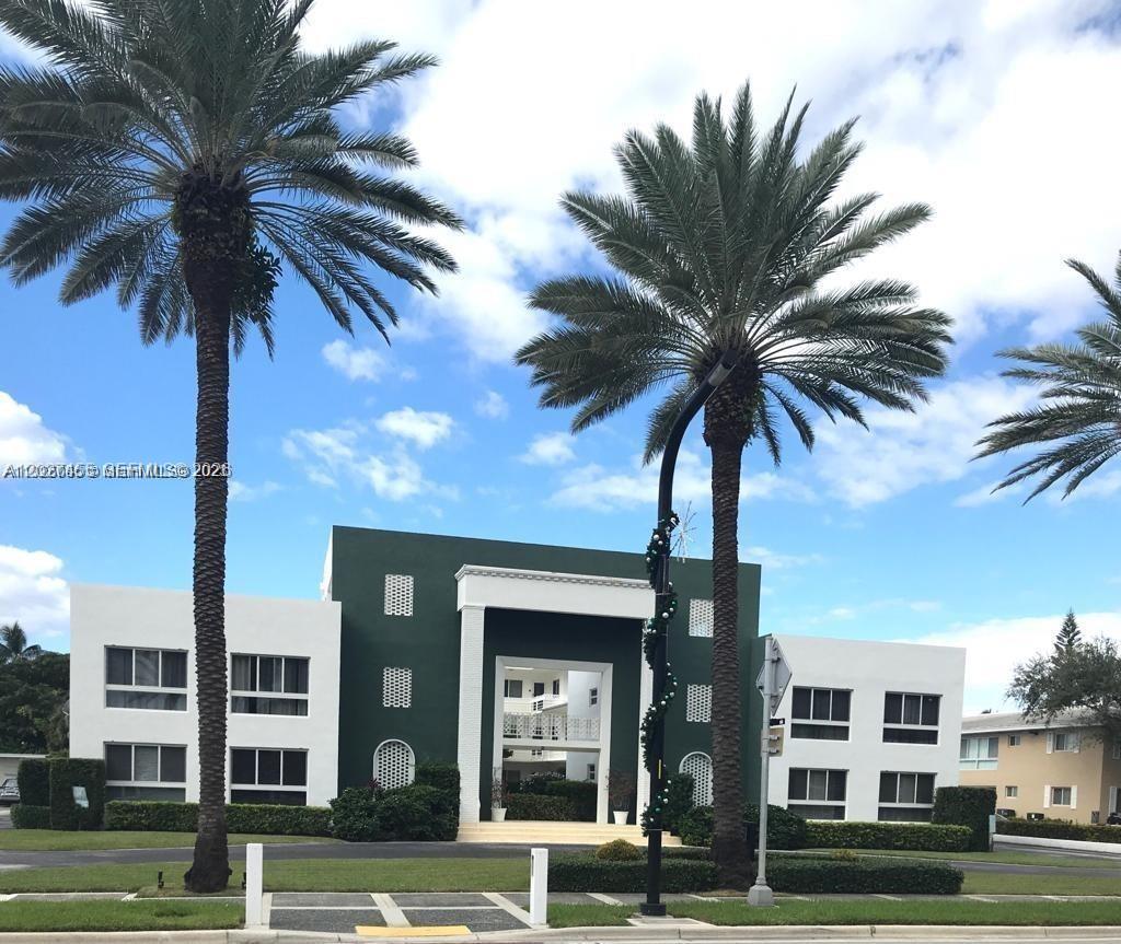 A two-story building with a green center section and white wings stands behind palm trees — 9920 Collins Ave # 1, Bal Harbour FL 33154, BAL HARBOUR, FL