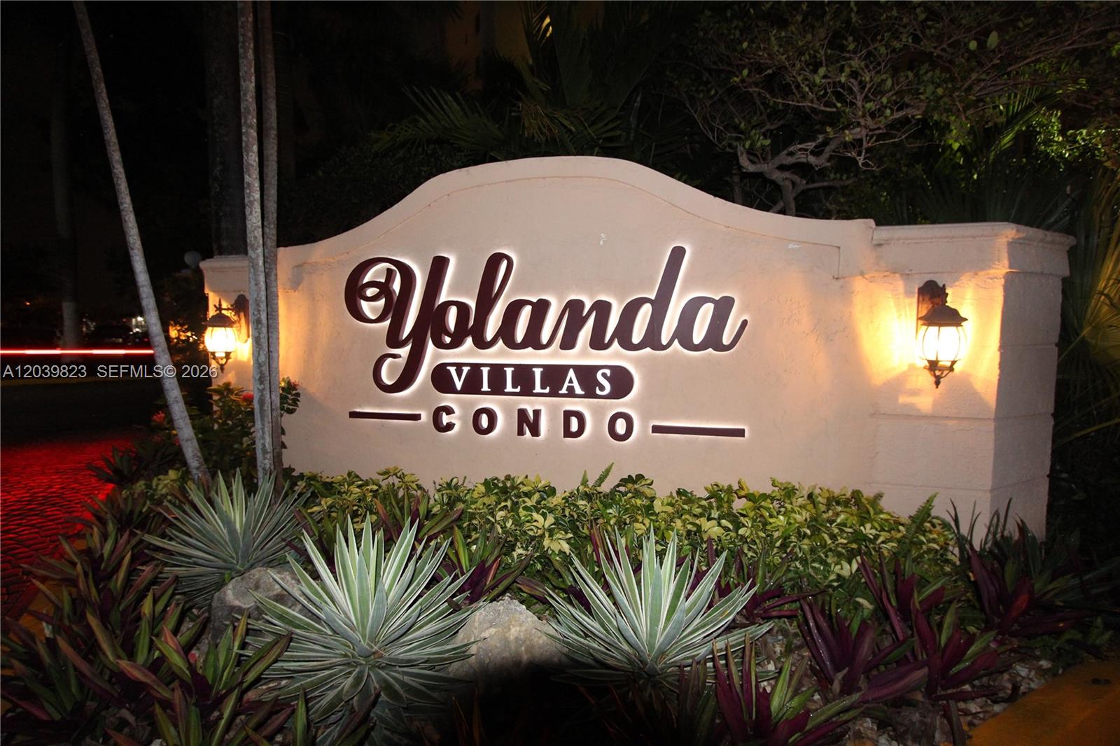 A lighted monument sign for Yolanda Villas Condo sits amidst landscaping at night — 4550 NW 9th St # 817E, Miami FL 33126, MIAMI, FL