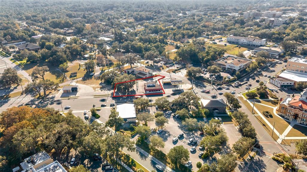 An aerial view shows a commercial property outlined in red situated at a busy intersection — 104 US HIGHWAY 41 S, INVERNESS, FL