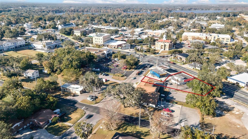An aerial view shows a commercial property outlined in red within a suburban town setting — 104 US HIGHWAY 41 S, INVERNESS, FL