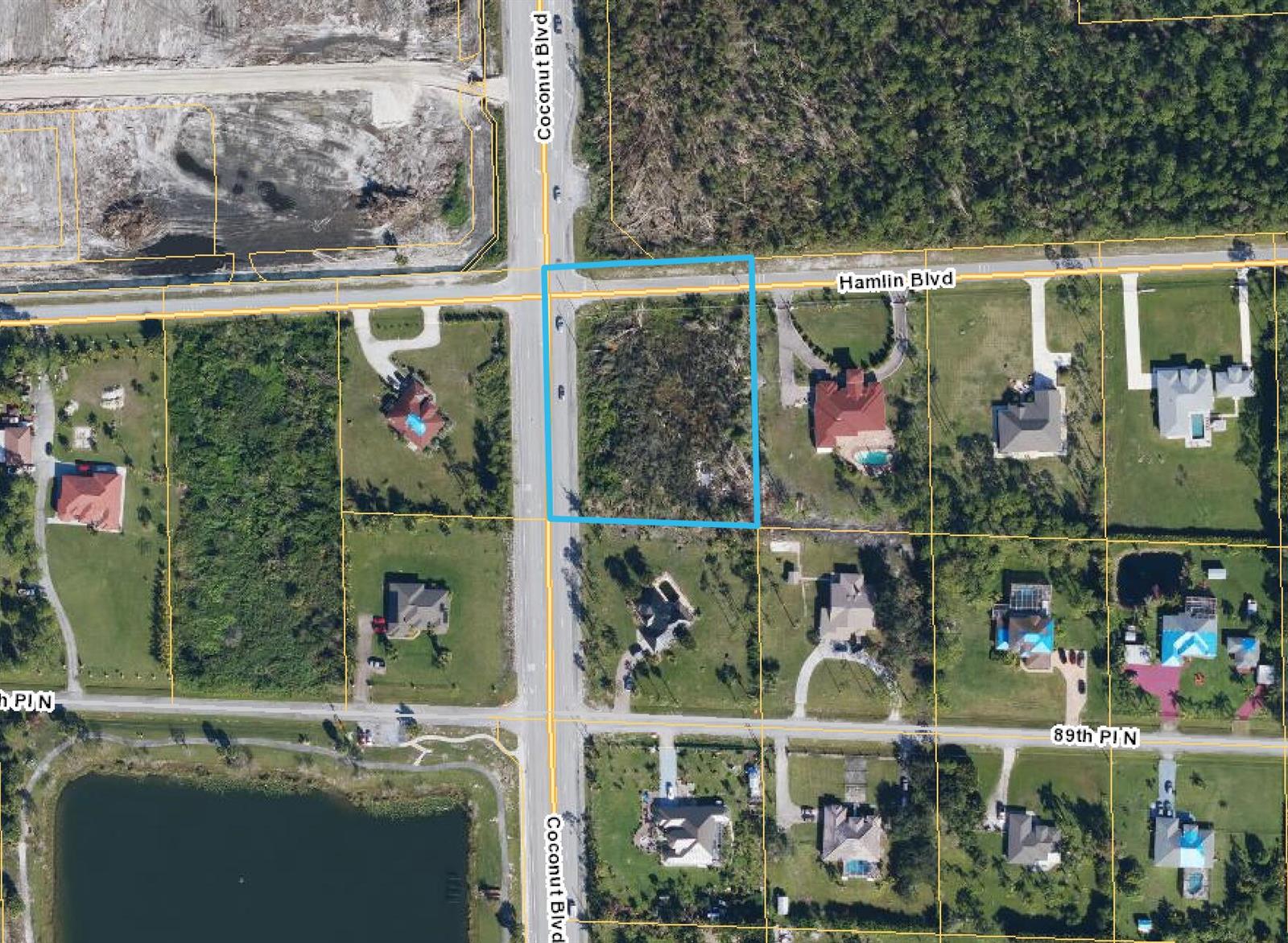 This is an aerial map showing a vacant, rectangular lot highlighted in blue at an intersection — 0000 Hamlin Blvd, FL 33412, FL