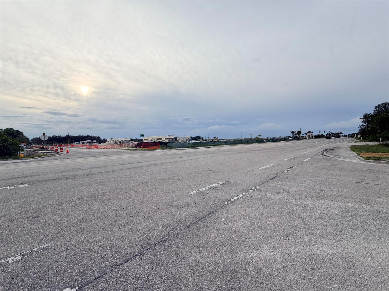 An expansive, empty paved intersection under a cloudy sky with construction visible in the distance — 0000 Hamlin Blvd, FL 33412, FL