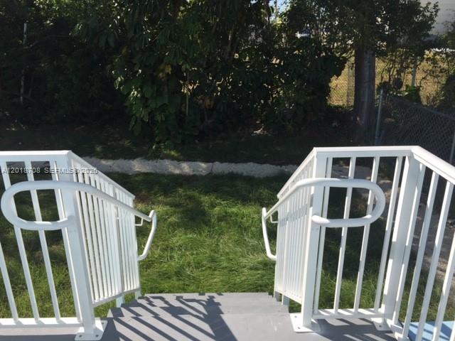 A view from the top of outdoor stairs looking down toward a grassy yard — 265 15th St # B, Marathon FL 33050, MARATHON, FL