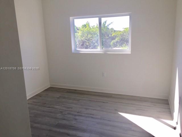 An empty bedroom features light gray wood-look flooring, white walls, and a single window — 265 15th St # B, Marathon FL 33050, MARATHON, FL