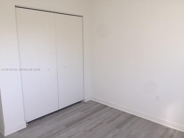 A room with white walls, light gray wood-look flooring, and a white double-door closet — 265 15th St # B, Marathon FL 33050, MARATHON, FL