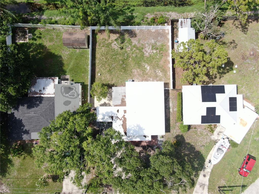 An aerial view shows a residential property with multiple buildings, a fenced yard, and trees — 4112 W LAWN AVENUE, TAMPA, FL