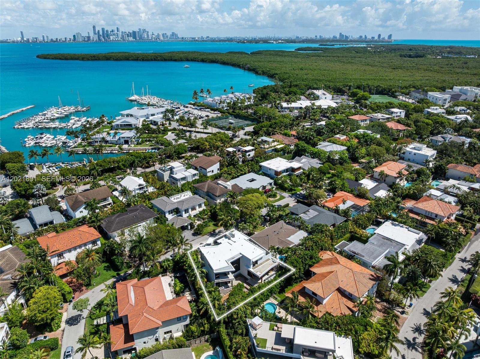 An aerial view shows a modern white house surrounded by lush trees and residential homes — 238 Buttonwood Dr, Key Biscayne FL 33149, KEY BISCAYNE, FL