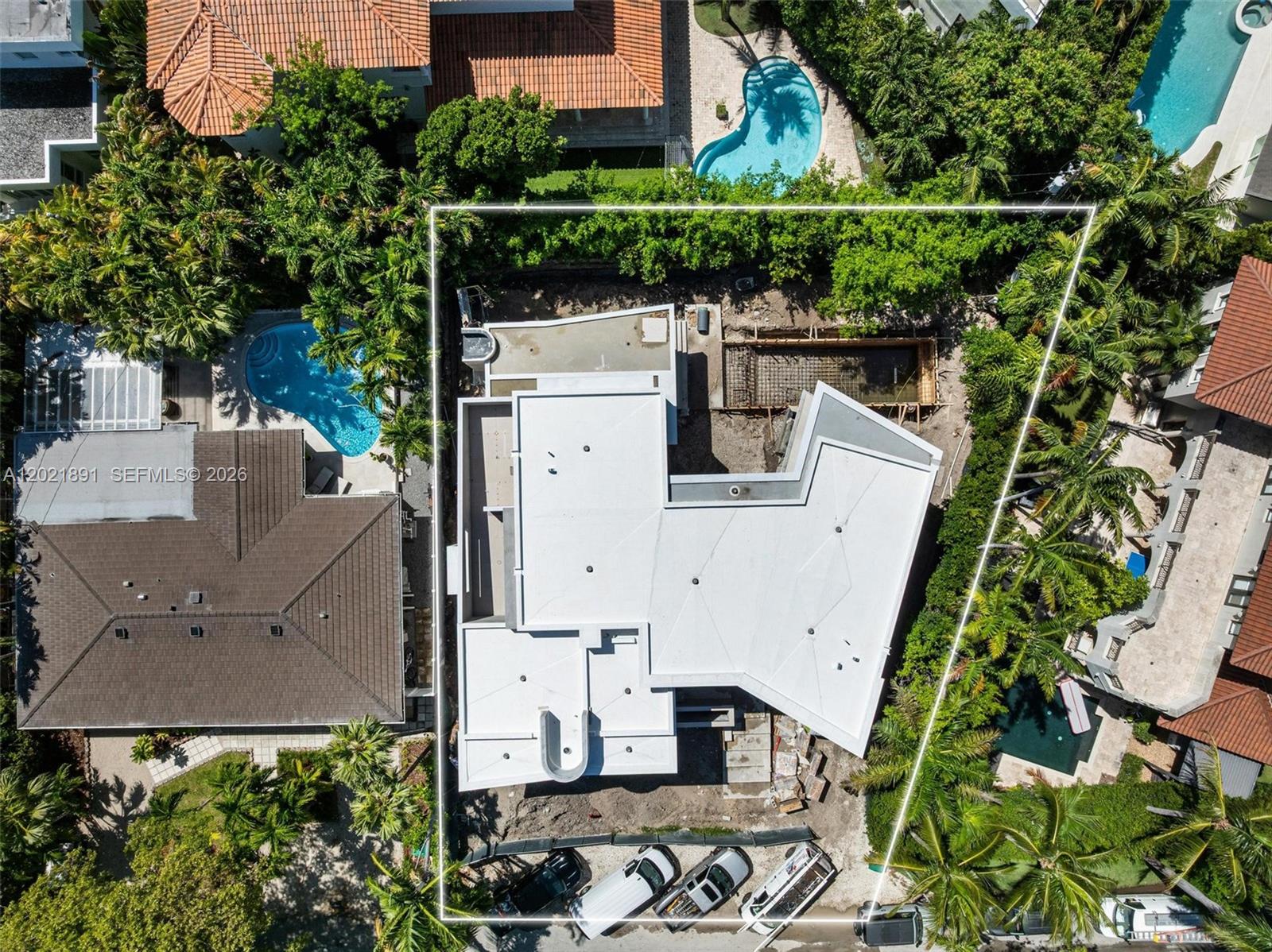 An aerial view shows a modern house under construction with a white roof and pool — 238 Buttonwood Dr, Key Biscayne FL 33149, KEY BISCAYNE, FL