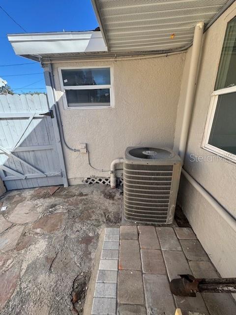 An outdoor area features a stucco wall, a window, and an air conditioning unit — 330 S. BUENA VISTA AVENUE, ORLANDO, FL