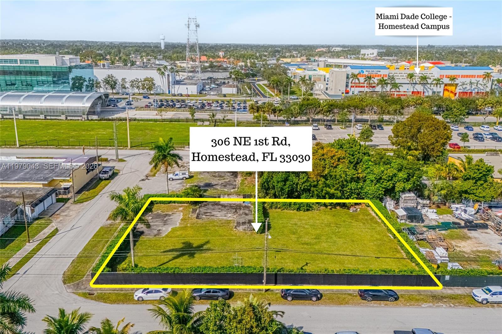 An aerial view shows a vacant, fenced rectangular lot with concrete pads in a suburban area — 306 NE 1st Rd, Homestead FL 33030, HOMESTEAD, FL
