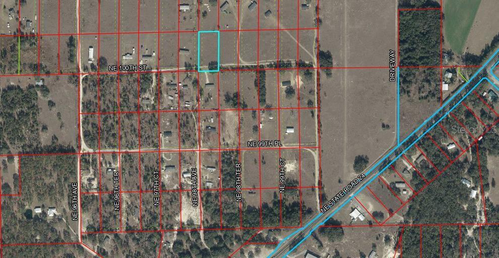 This is an aerial map showing a rectangular parcel of land outlined in light blue — Lot 217 NE 100TH ST, ARCHER, FL