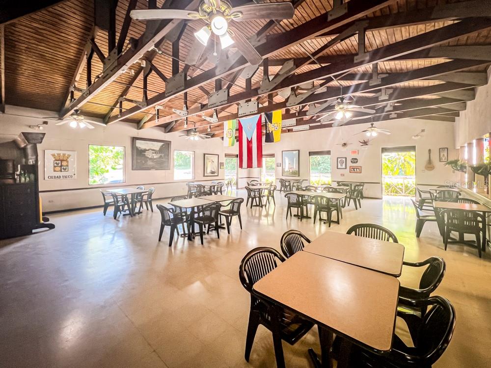 A spacious dining hall features a high vaulted wood-beam ceiling, multiple ceiling fans, and tables — 127 KM 4.3 BO. QUEBRADAS AVENUE, GUAYANILLA, PR