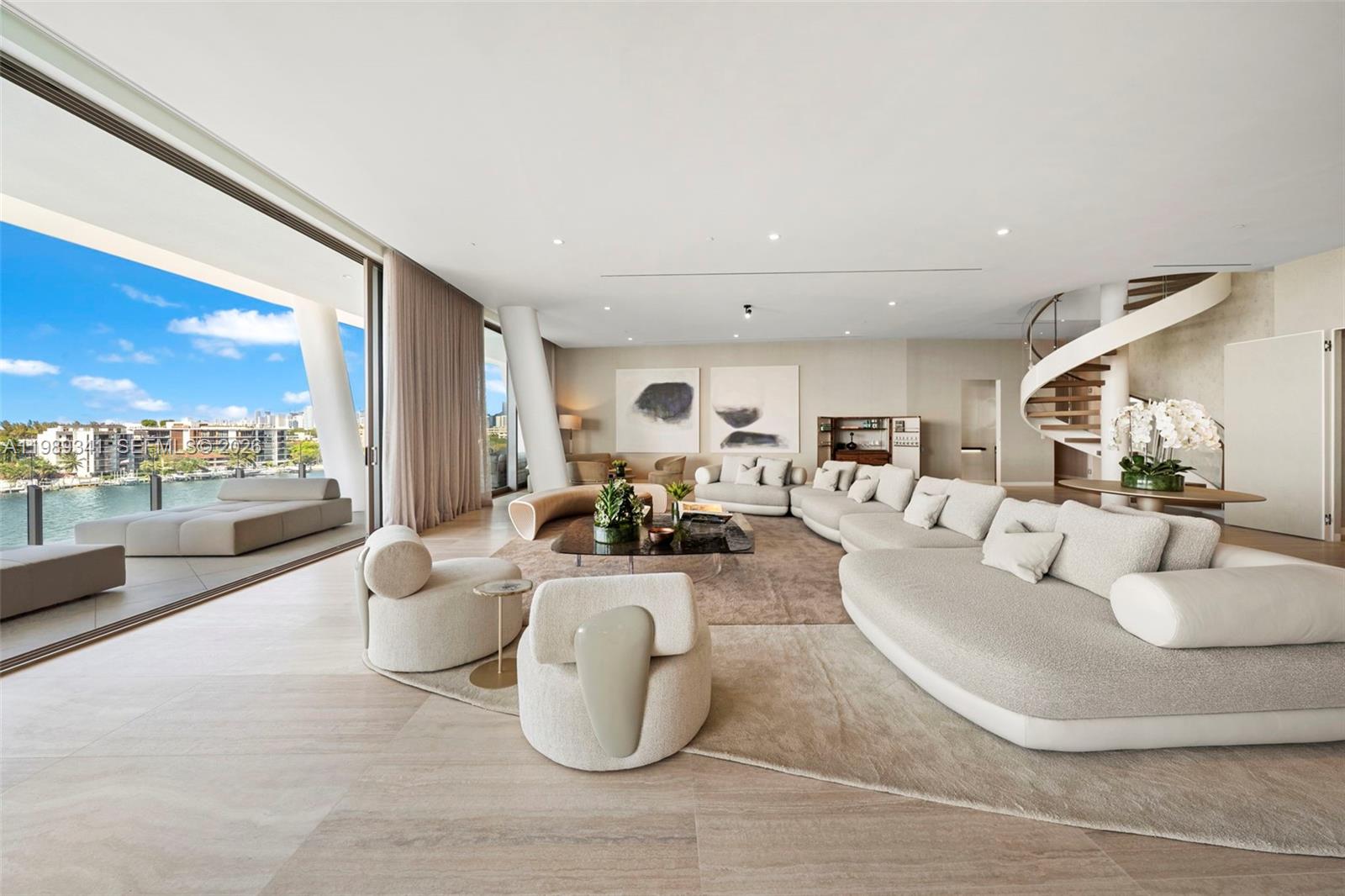 A spacious living room features a large curved sofa, spiral staircase, and floor-to-ceiling balcony doors — 5 Grove Isle Dr, Coconut Grove FL 33131, COCONUT GROVE, FL