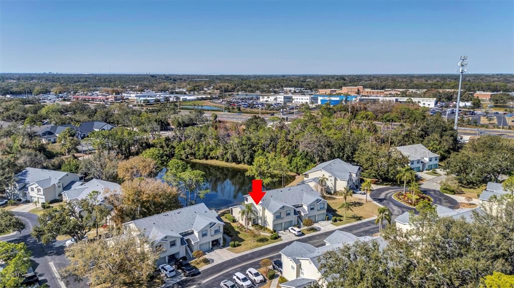 A two-story townhouse with a beige stucco exterior, two garage doors, and a front lawn — 5430 FAIR OAKS STREET UNIT 5430, BRADENTON, FL