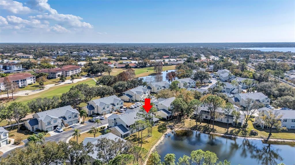 An exterior view of a two-story residential building with screened balconies and a patio — 5430 FAIR OAKS STREET UNIT 5430, BRADENTON, FL