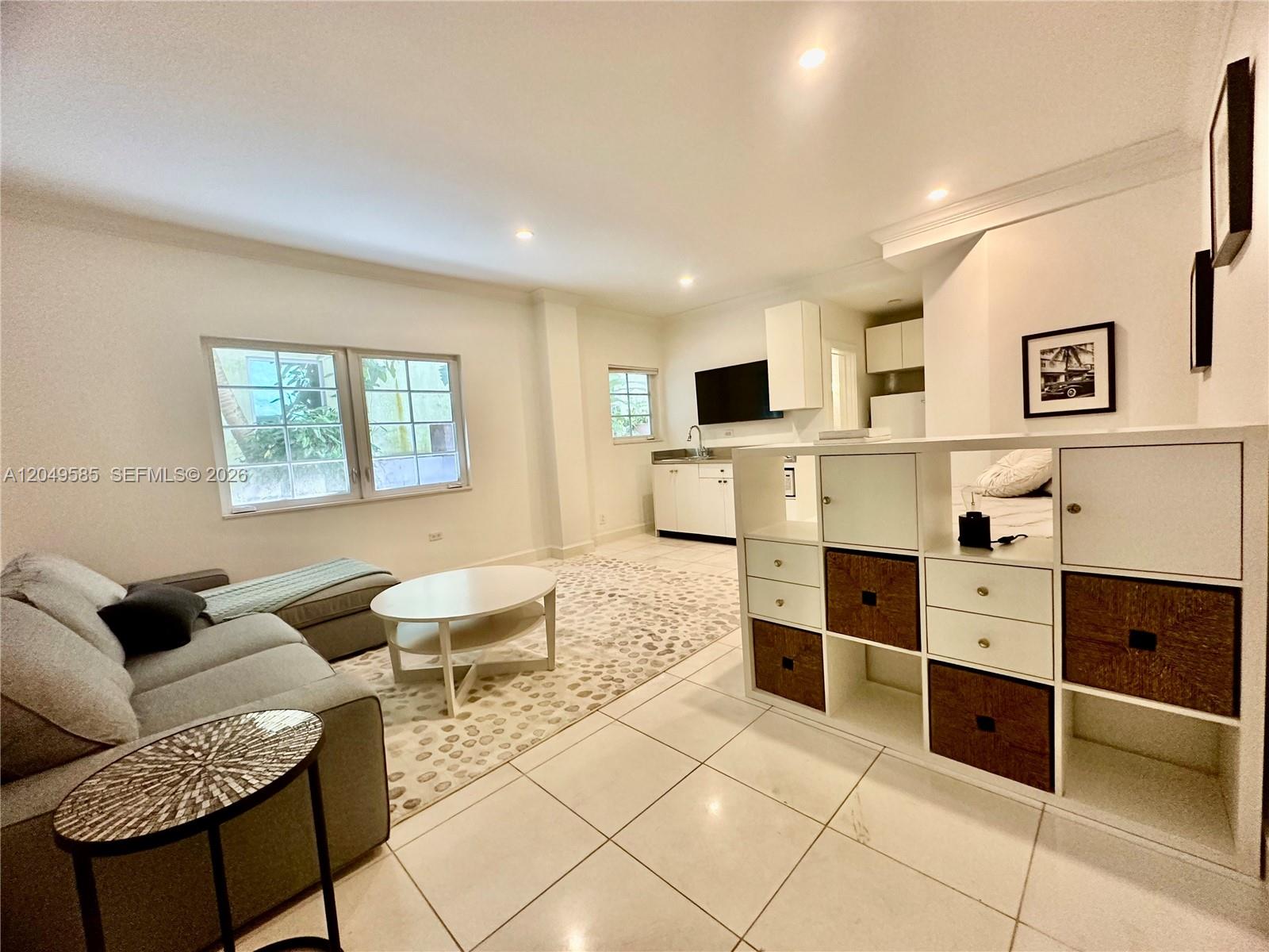 A studio apartment features a living area, kitchenette, and a white shelving unit room divider — 260 Euclid Ave # 6, Miami Beach FL 33139, MIAMI BEACH, FL