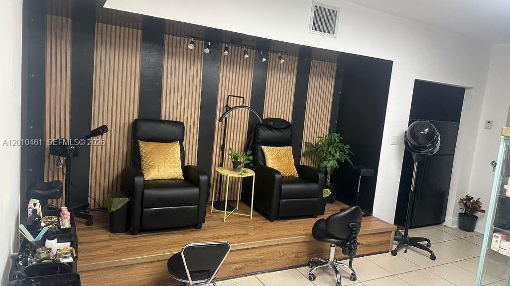 A salon area features two black reclining chairs on a raised wood-look platform — 9610 Fontainebleau Blvd, Miami FL 33172, MIAMI, FL