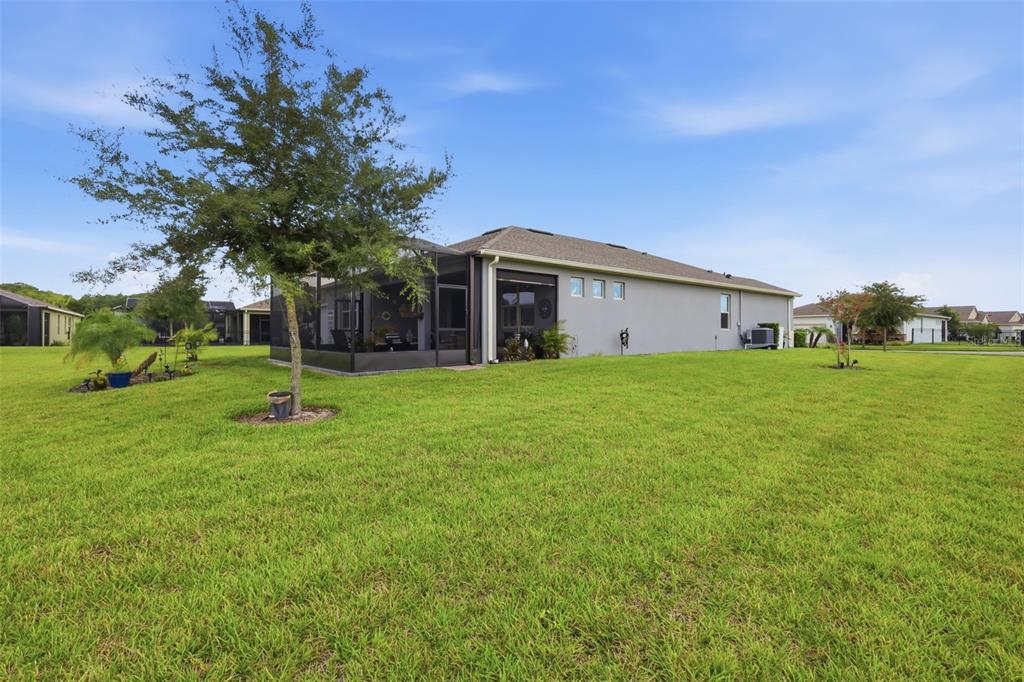 A single-story suburban house with a gray exterior, a two-car garage, and a landscaped yard — 17762 BLAZING STAR CIRCLE, CLERMONT, FL