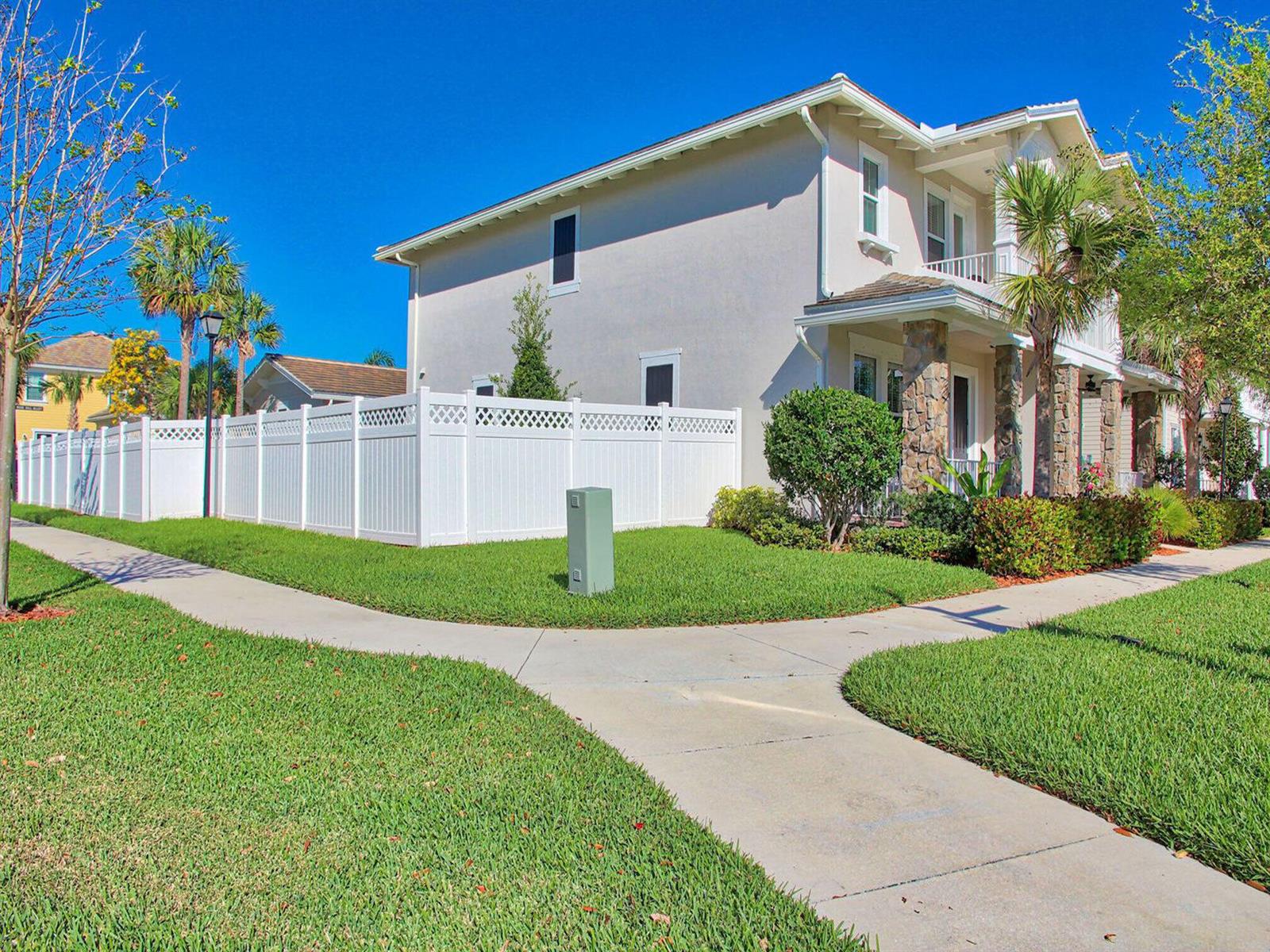A two-story house with a white vinyl fence and a sidewalk in the front yard — 2758 Avalon Way, Jupiter FL 33458, JUPITER, FL
