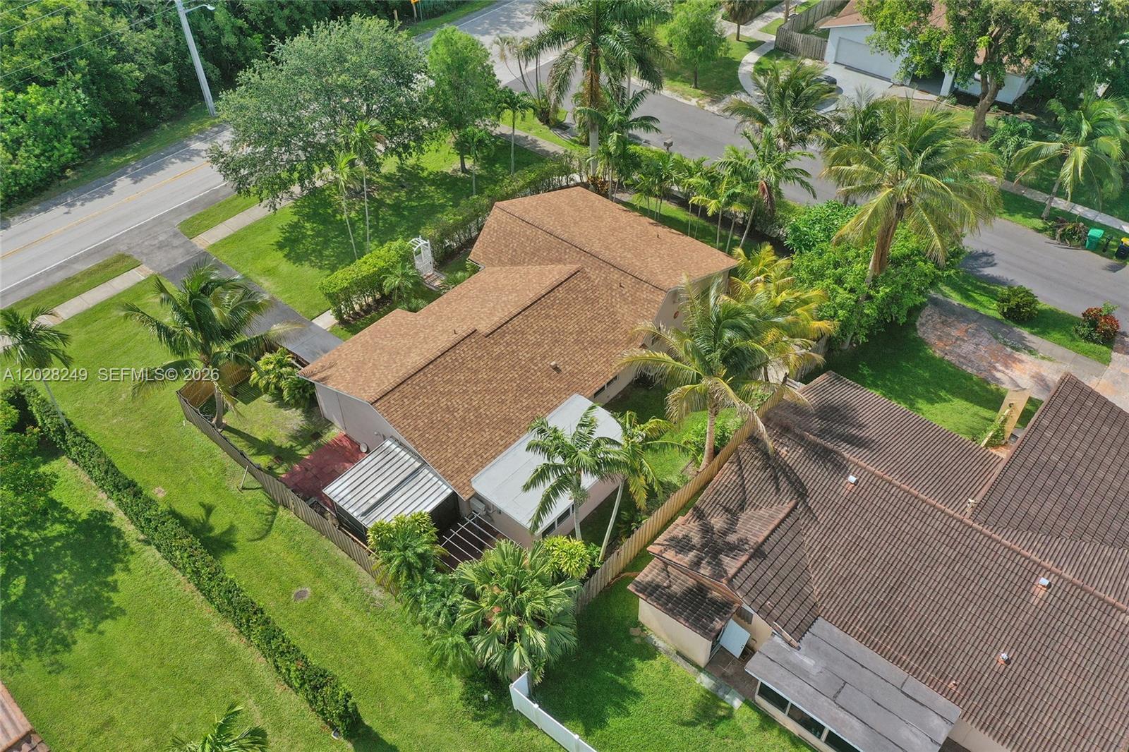 An aerial view shows a single-story house with a brown shingled roof and palm trees — 417 SE 4th St, Dania Beach FL 33004, DANIA BEACH, FL