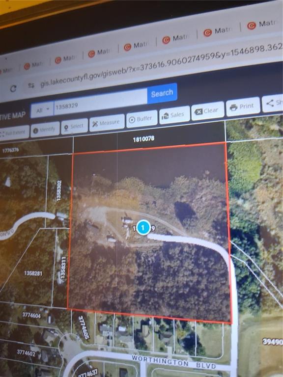 This is a satellite map view showing a rectangular property parcel outlined in red — 16451 FORREST LANE, GROVELAND, FL
