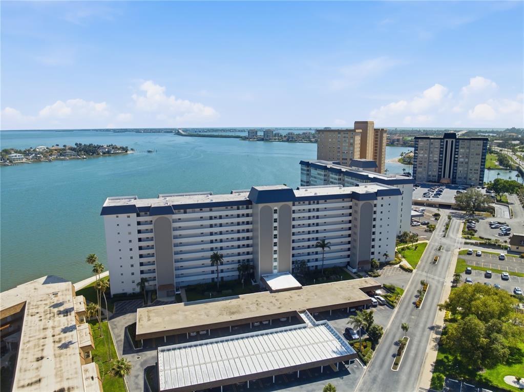 An aerial view shows a large apartment complex situated along a waterfront — 5108 BRITTANY DRIVE S UNIT 506, ST PETERSBURG, FL