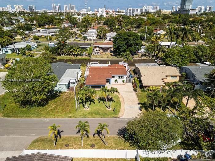 An aerial view of a residential property with a red roof and a paved driveway — 707 SW 3rd Ave, Hallandale Beach FL 33009, HALLANDALE BEACH, FL
