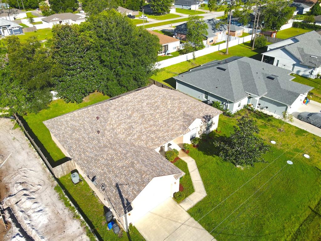 An aerial view shows a single-story house with a shingled roof and a concrete driveway — 16 ZORLOU COURT, PALM COAST, FL