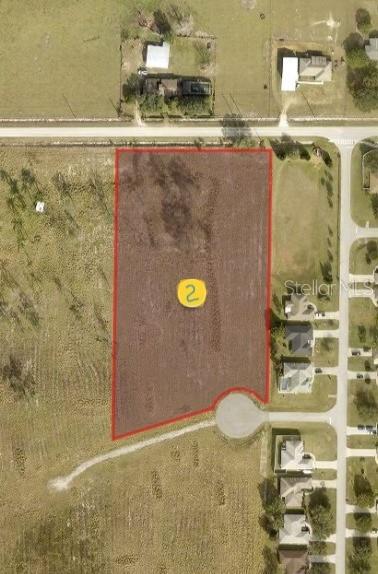An aerial view shows a vacant rectangular lot marked with the number two — Lot 2 MERCADO COURT, CLERMONT, FL