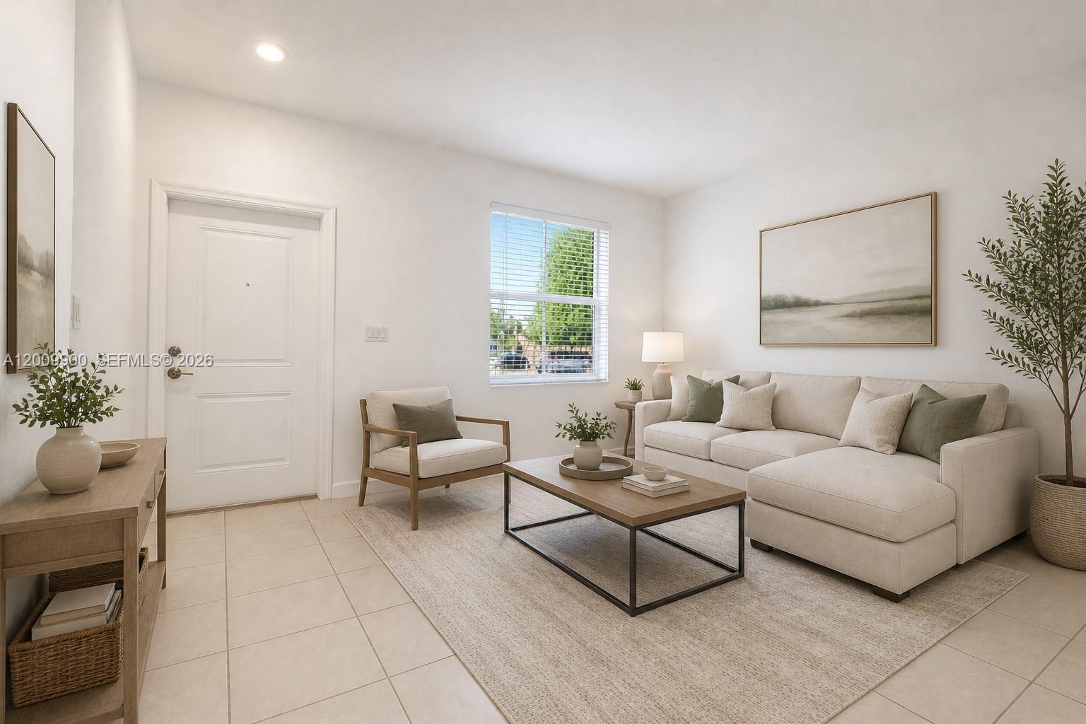 A living room features a beige sectional sofa, a coffee table, and a neutral rug — 2664 SE 19th St, Homestead FL 33035, HOMESTEAD, FL