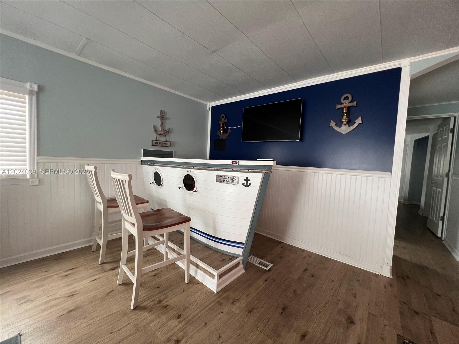 A room features a boat-shaped bar, two white chairs, and nautical decor on blue walls — 8709 SW 15th St, Davie FL 33324, DAVIE, FL