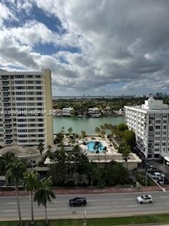 An elevated view of a waterway between two apartment buildings with a swimming pool below — 5601 Collins ave # 1219, Miami Beach FL 33140, MIAMI BEACH, FL