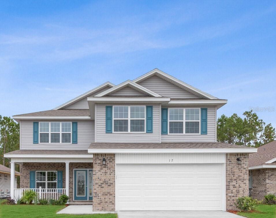 A two-story house features gray horizontal siding, a brick facade, and a two-car garage — 59 RADCLIFFE  DRIVE, PALM COAST, FL