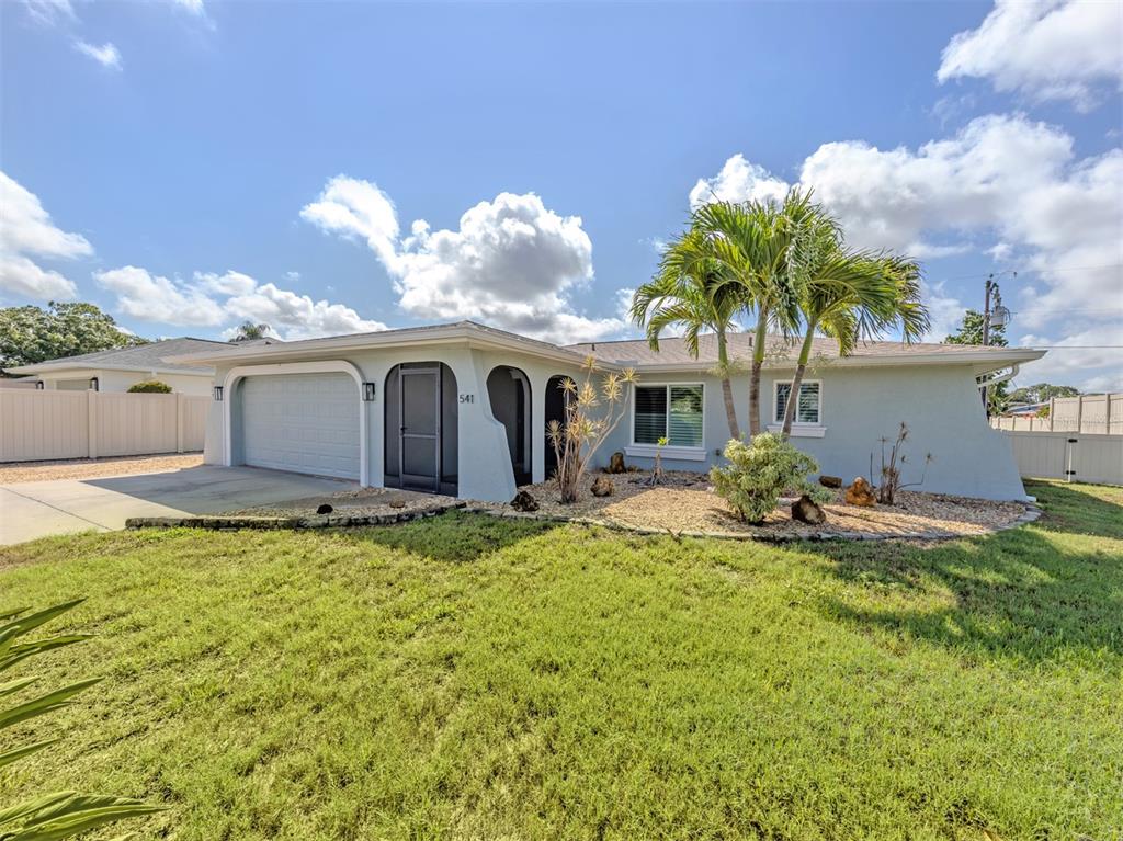 A single-story house with a light blue exterior, a garage, and a palm tree — 541 CARMEL ROAD, VENICE, FL